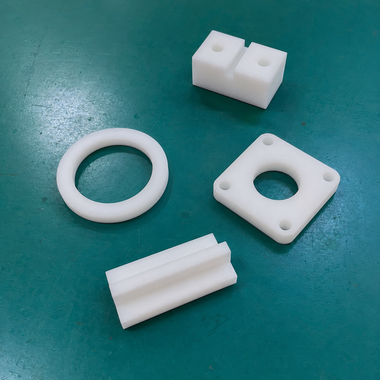 White and black PTFE components produced by CNC milling