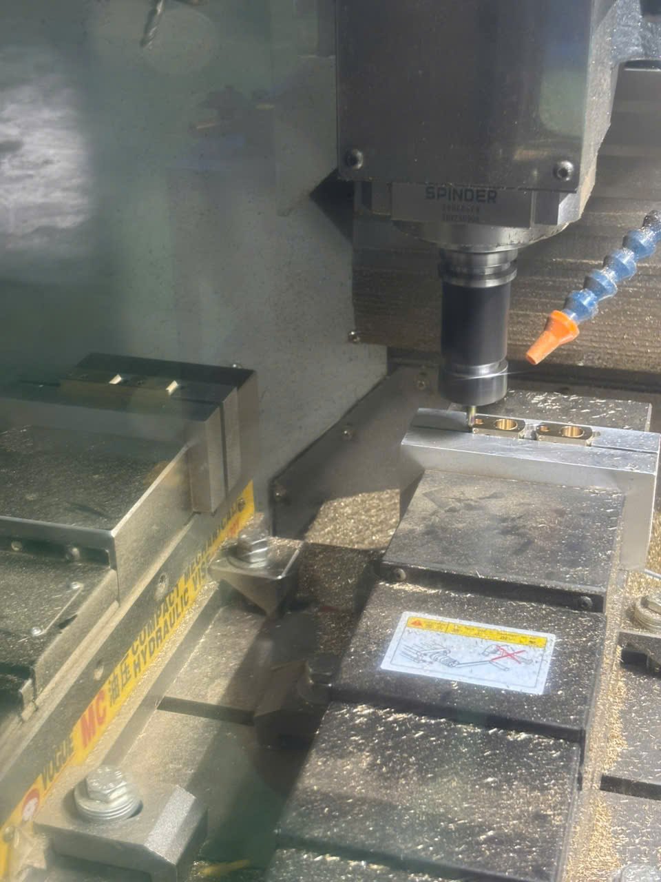 CNC milling machine cutting small brass components at OSM Vietnam