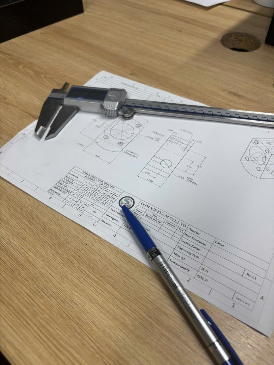Digital caliper and engineering drawing used for CNC machining design review